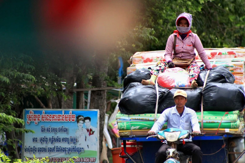 a man is sitting on the back of a truck