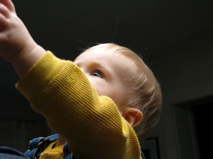 the little child is playing with the string of a kite