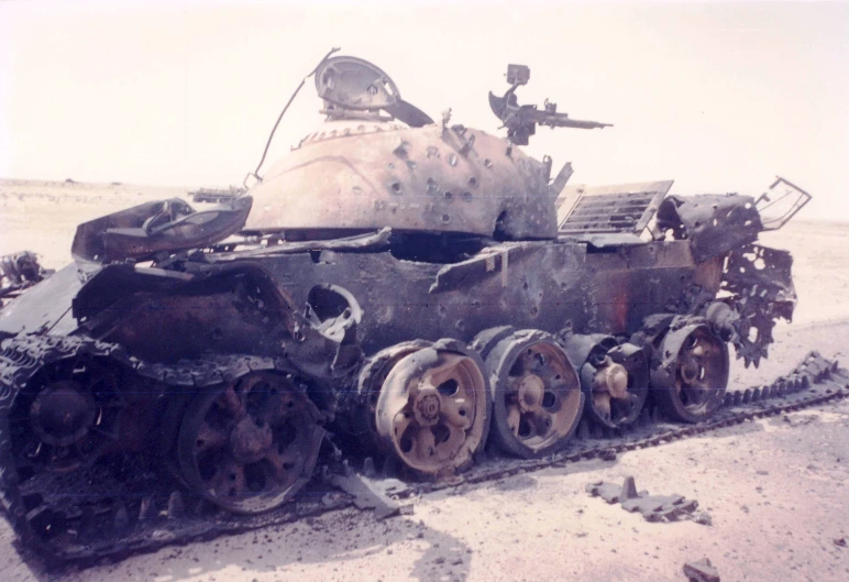 an old tank sitting on a dry field