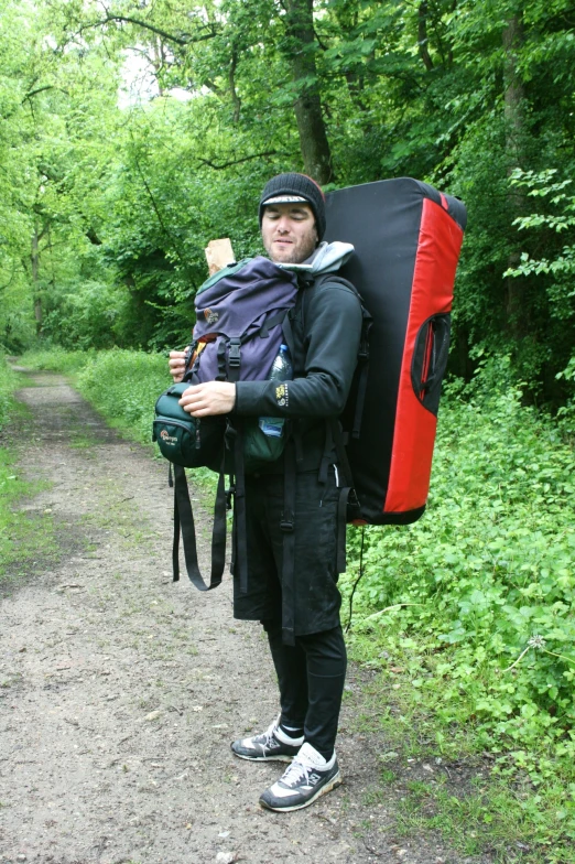 a person with a backpack standing on a road