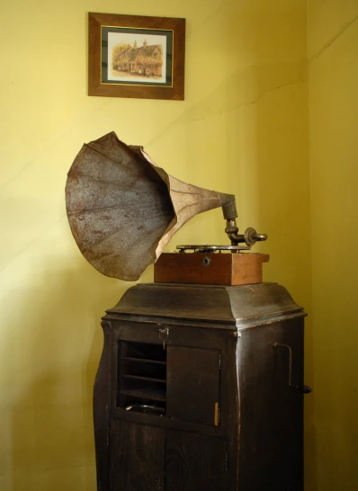a very old looking record player on a table with a record