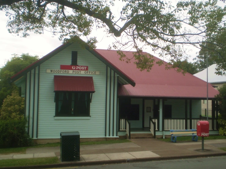 a small white building with a red roof