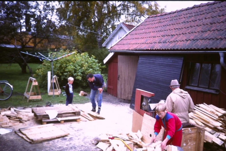 men working in a yard with wooden pallets