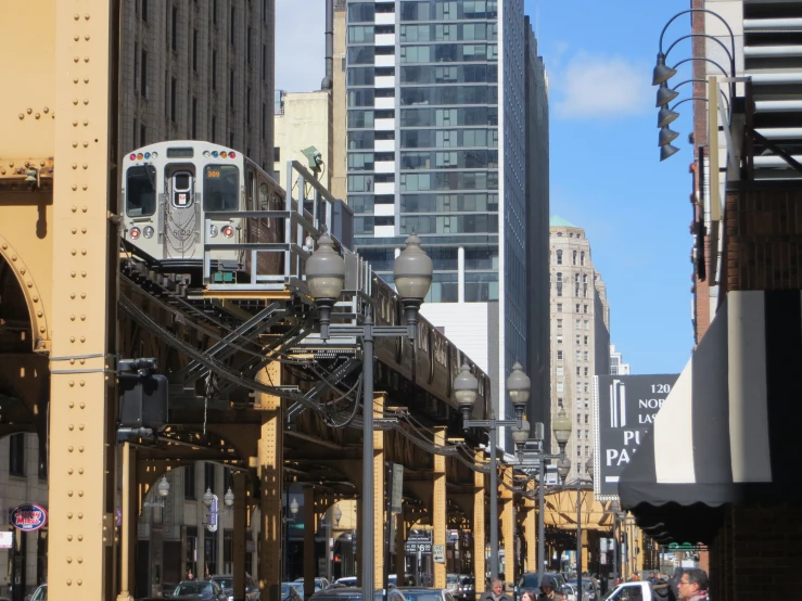 a city train on tracks near tall buildings