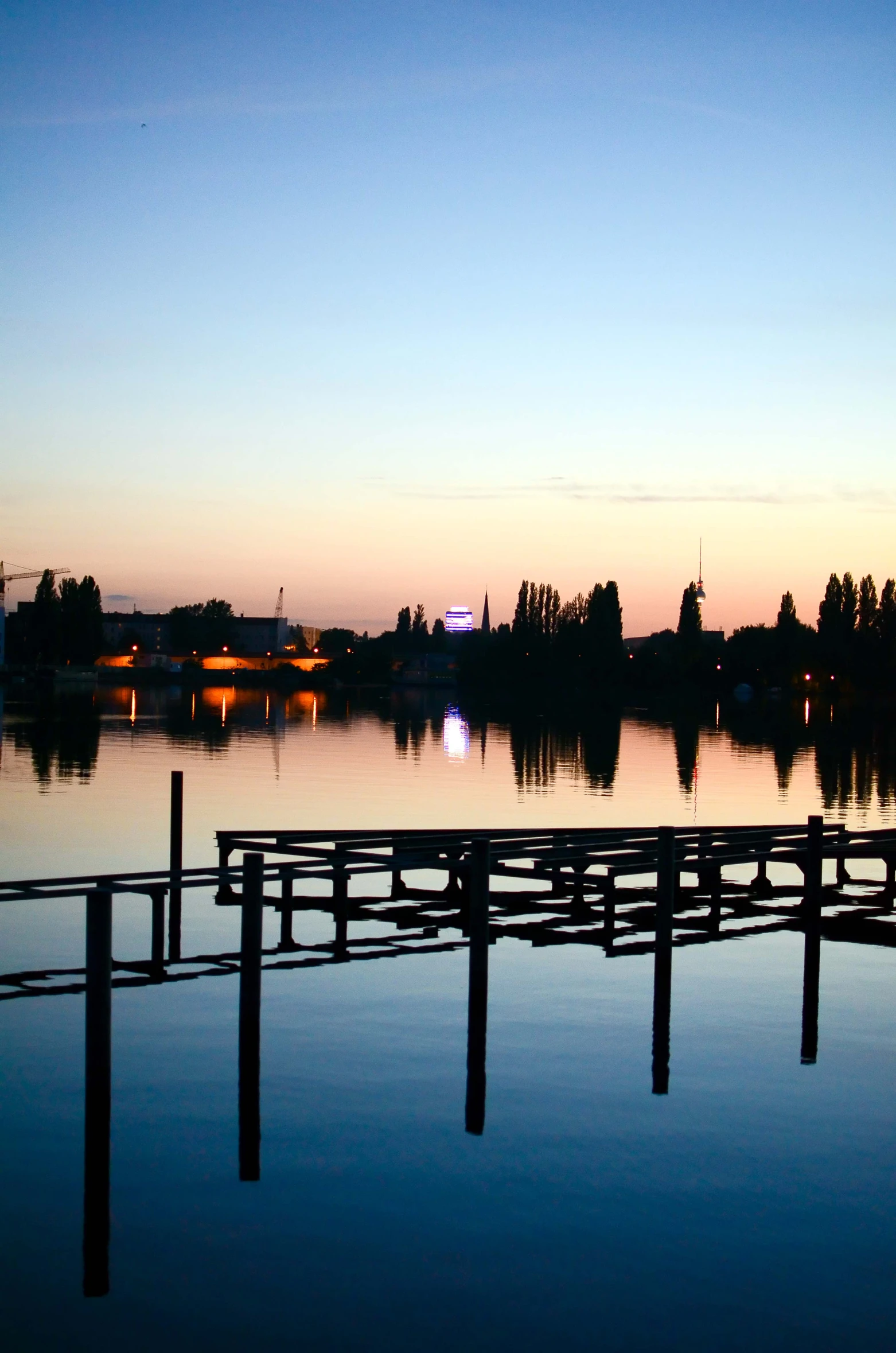 a pier at dusk with the sun on it