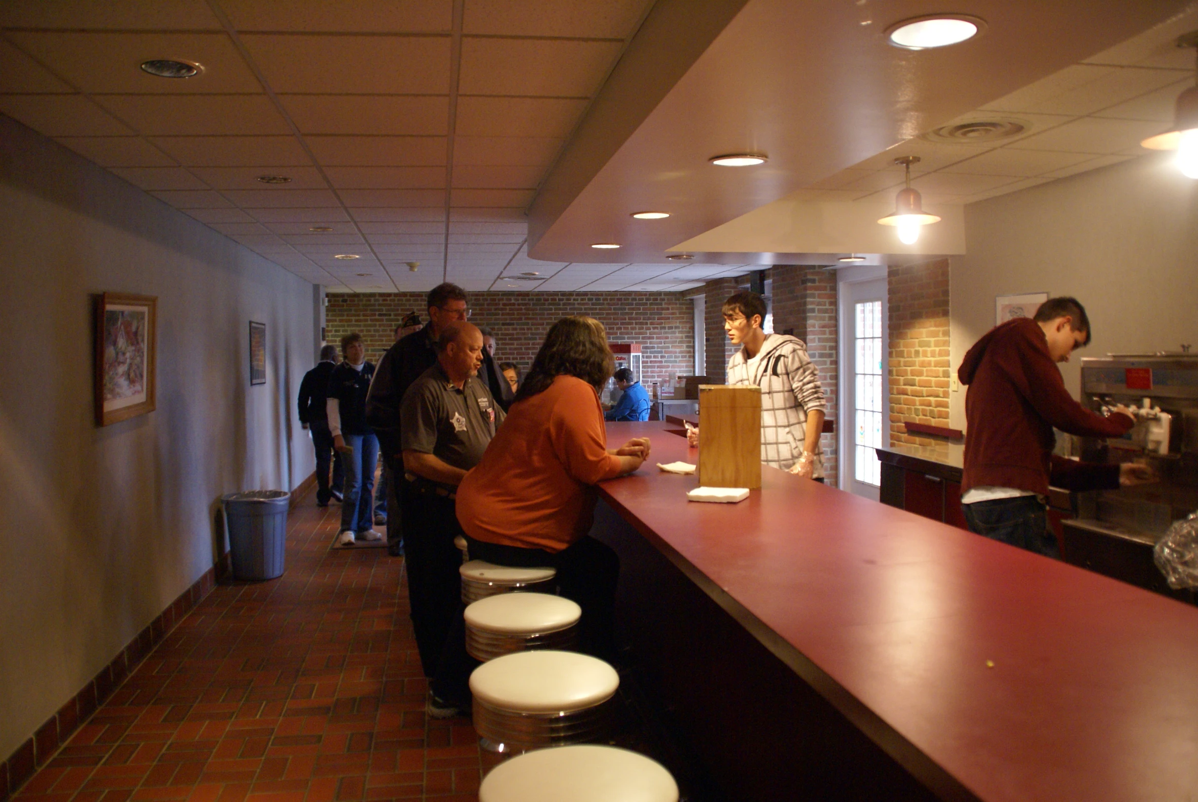 a group of people standing around a bar