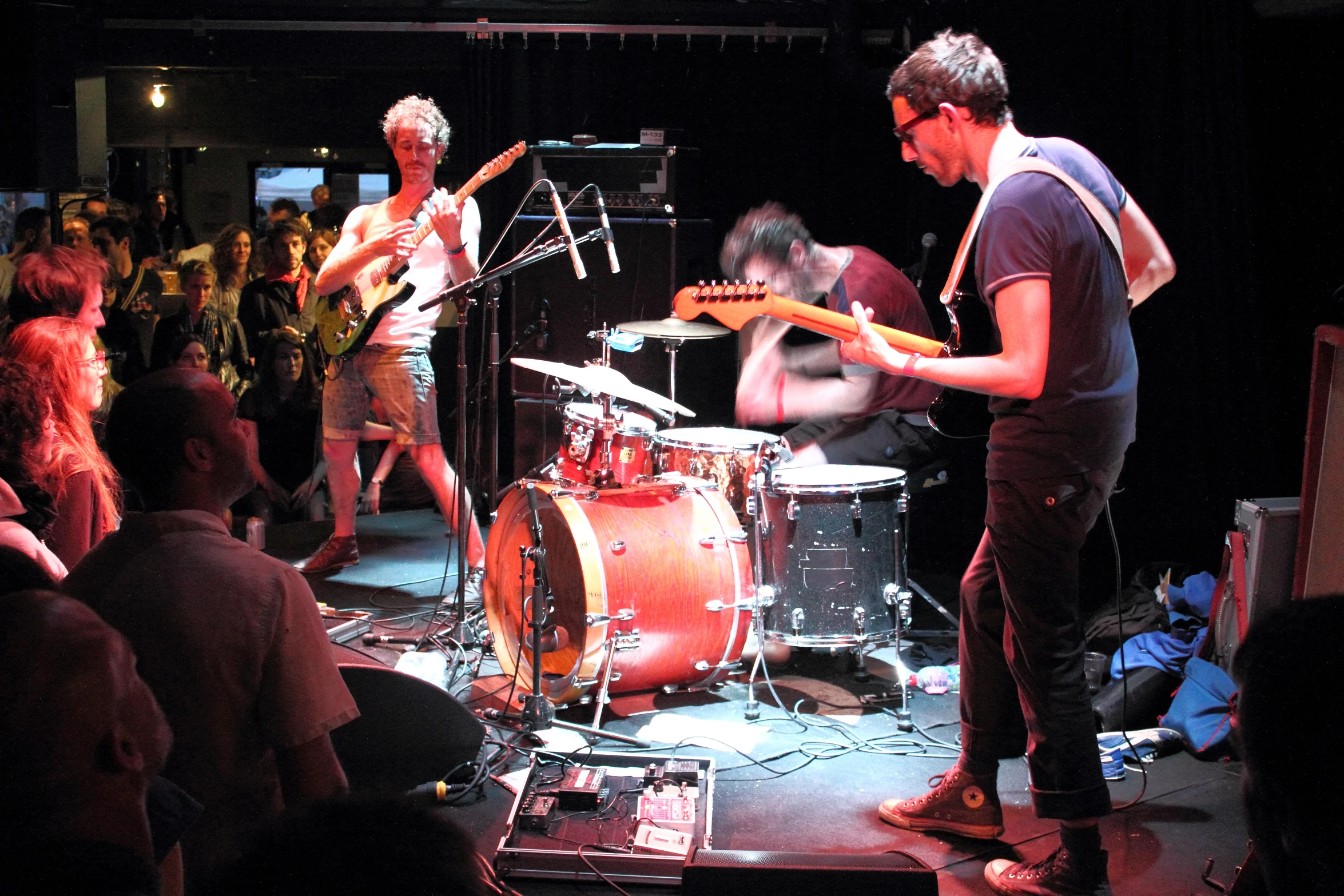 people are gathered at a band stage for the concert