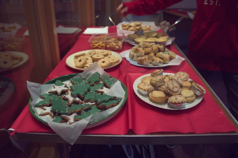 several plates filled with different kinds of cookies