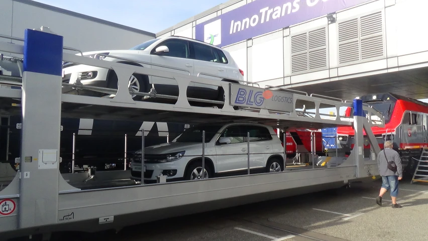 an image of a building with cars stacked on the side