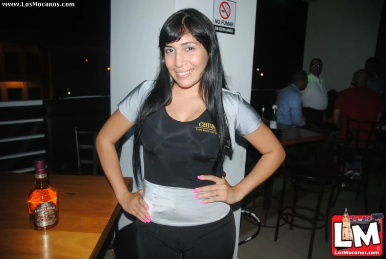 a woman standing in front of a table wearing an apron