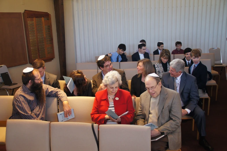 several people in chairs listening to an award