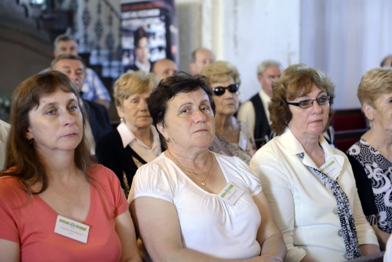 a group of women and men sitting in rows