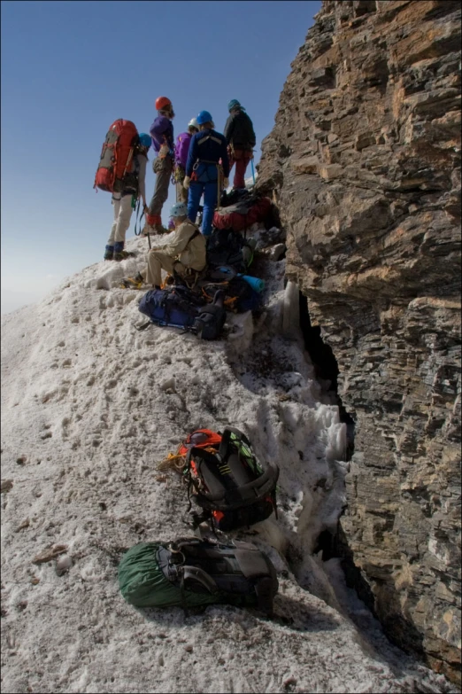 a group of hikers are ascending up a mountain