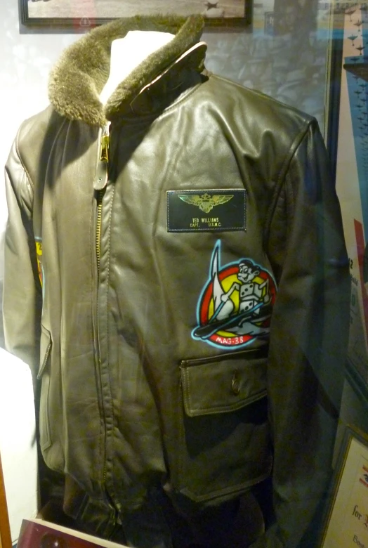 a green jacket with patches on the side