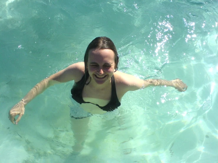 a woman swimming in clear blue water