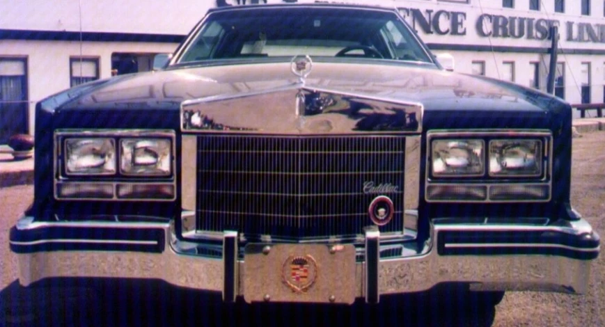 a vintage car parked in front of the renaissancee cruise building