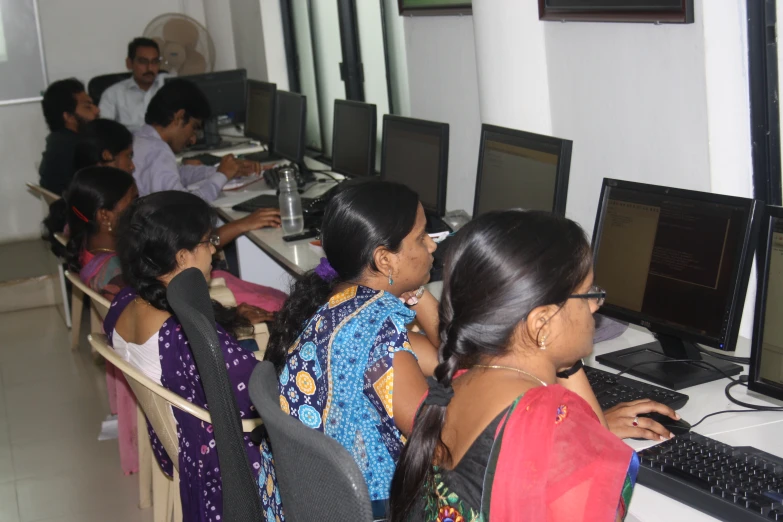 an indian group of people looking at laptop computers