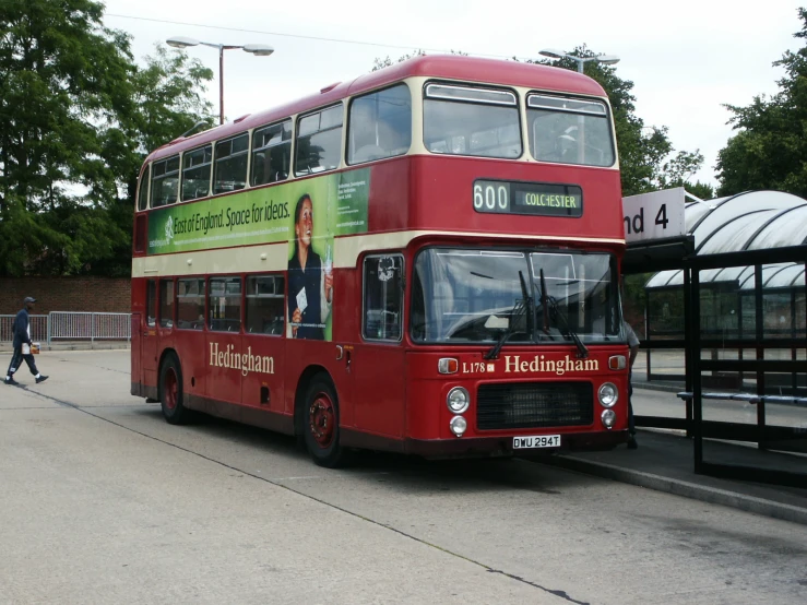 a red double decker bus is parked in the street