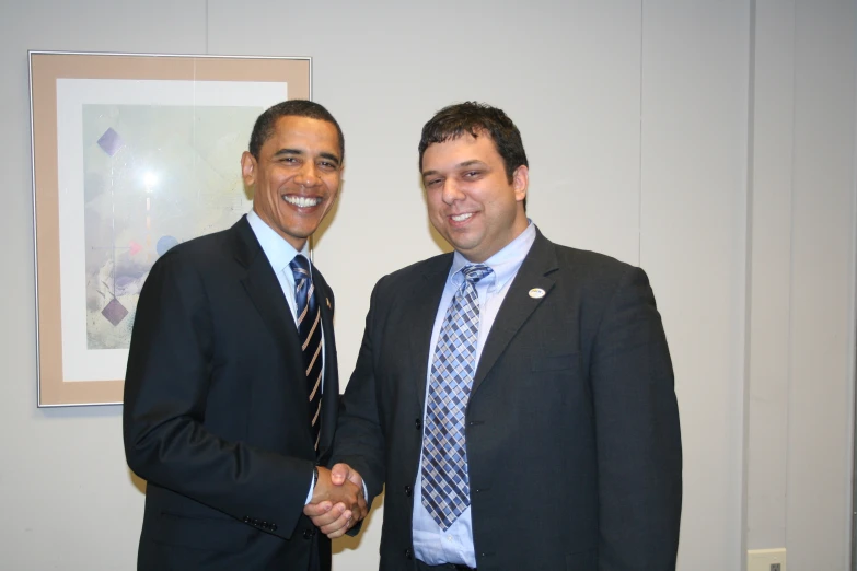 president obama greets a young man in suit and tie