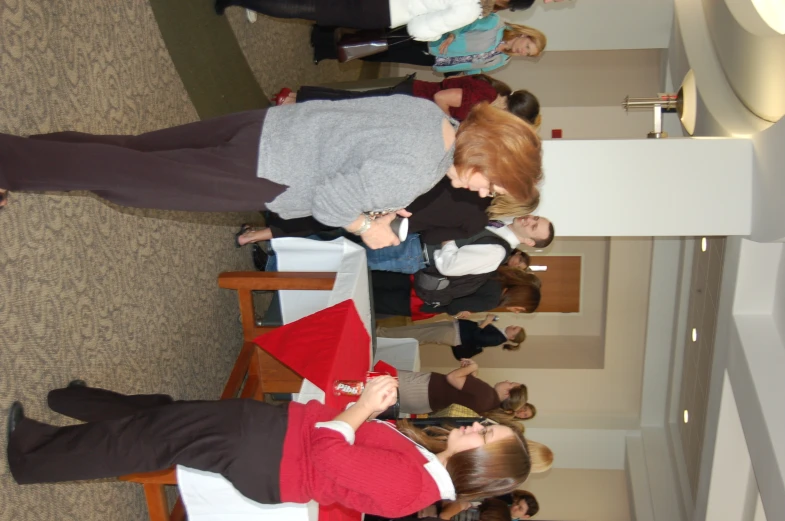 two women with wii remotes in front of a crowd