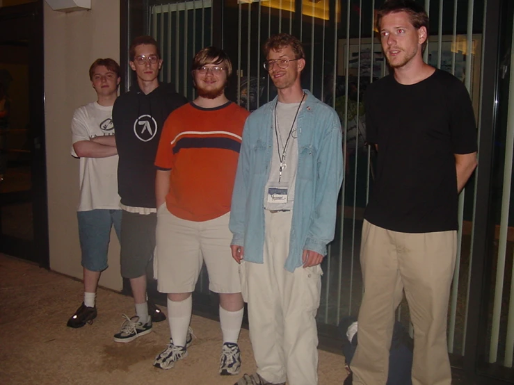 three men and two boys are standing close to each other