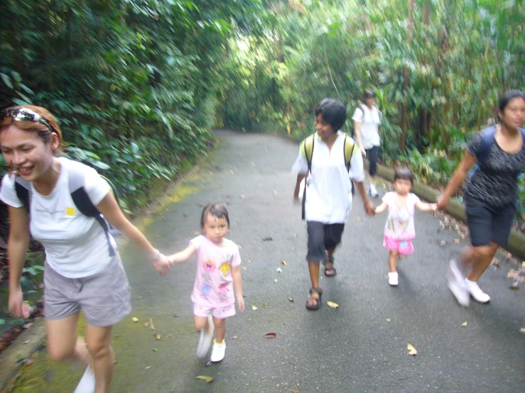 family on a pathway with backpacks and two s