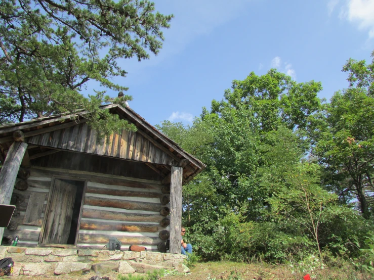 a cabin in the forest next to trees