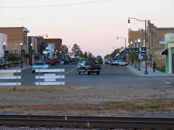 the view of some street with cars at dusk