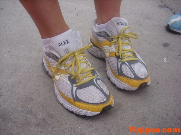 the legs and shoes of someone standing on cement