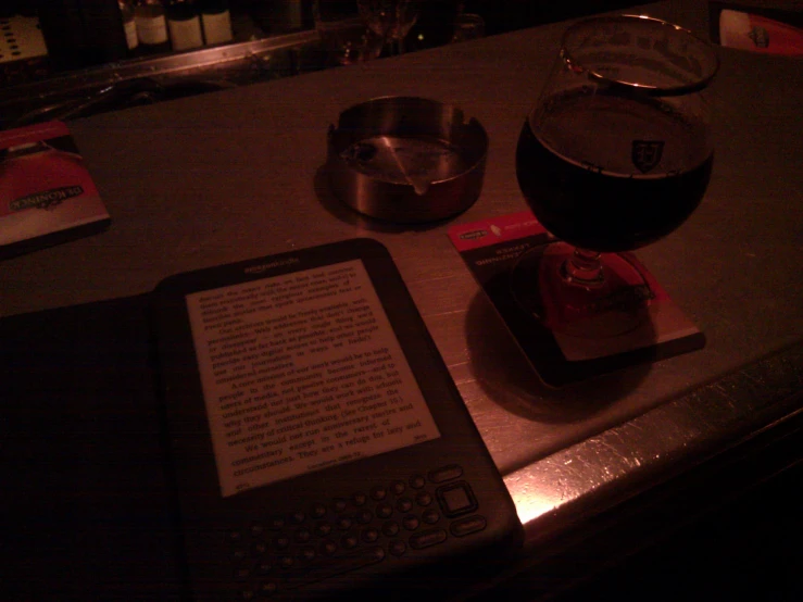 an electronic device sits on the bar in a dimly lit room