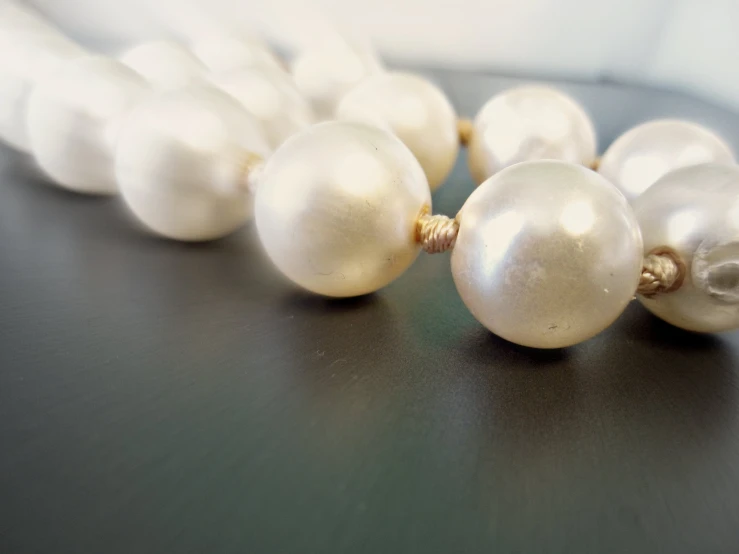 some pearls and other beads laying on a table