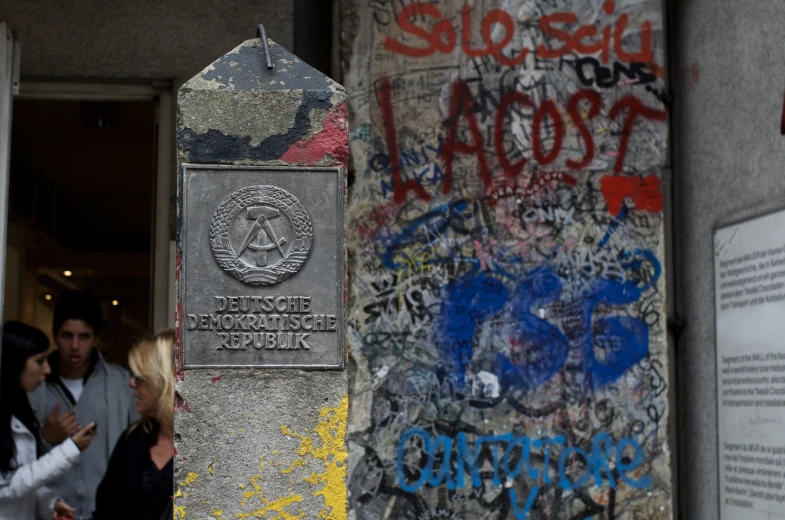 a large pillar with a sign that says the name is posted in front of it