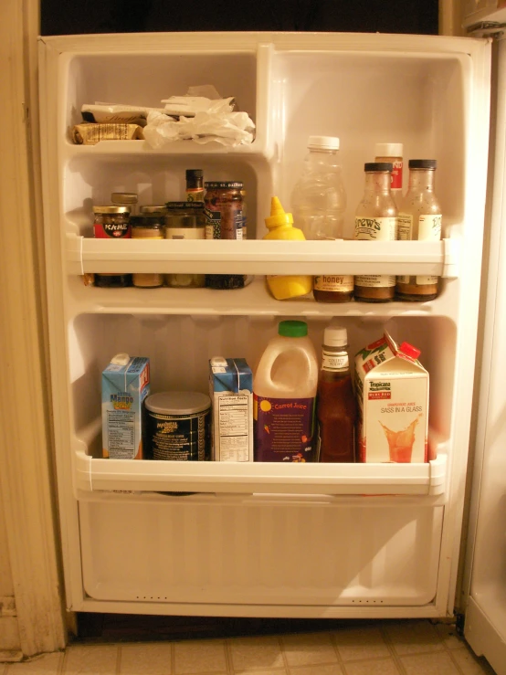 an empty refrigerator filled with different kinds of condiments