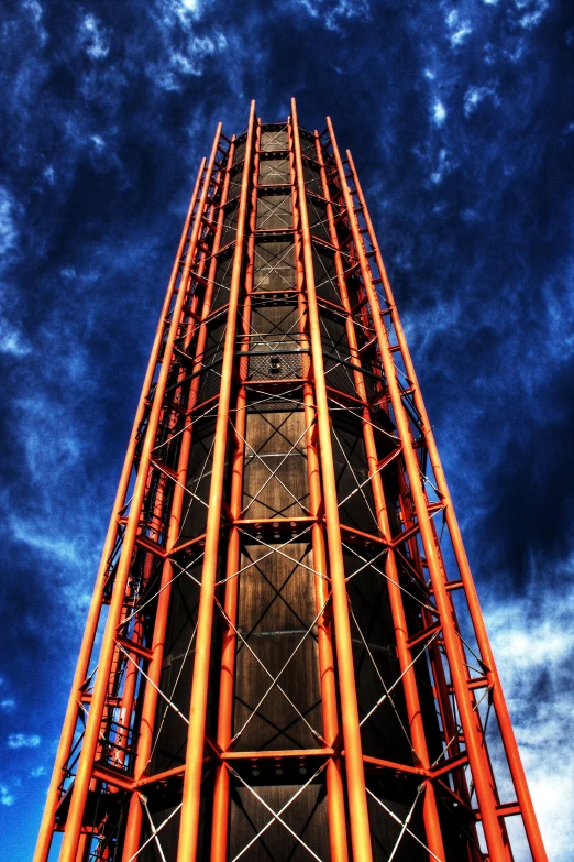 the large metal object is being displayed against the sky