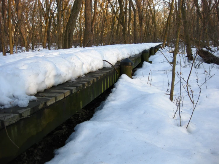 an old abandoned train trestle in the snow