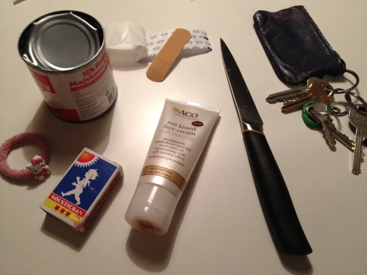 an assortment of beauty items sitting on a white surface