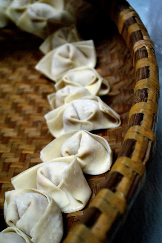 some noodles in a woven basket sitting on a table