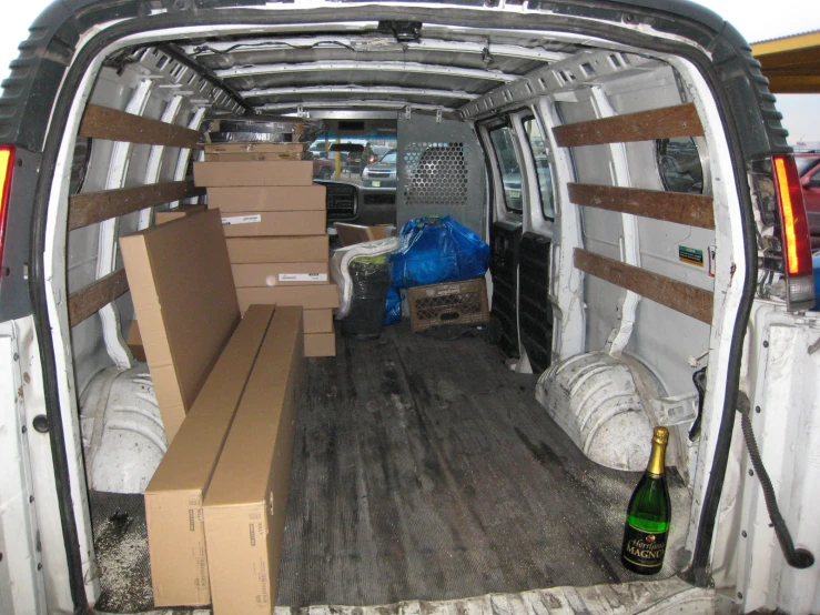 several cardboard boxes are stacked on the back of a truck