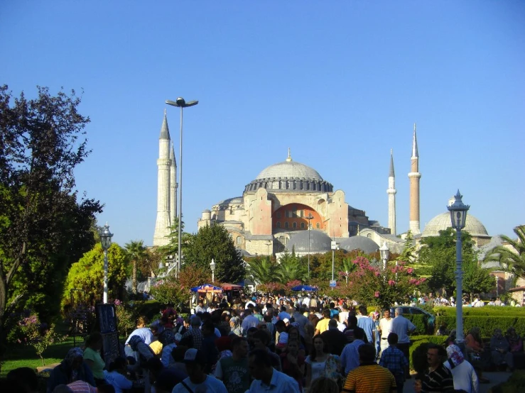 a large crowd in front of an ornate building