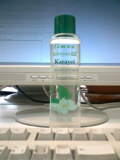 a bottle of kerazl sitting on top of a computer keyboard