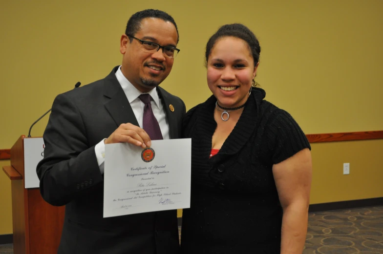 a couple is holding up a certificate for their wedding