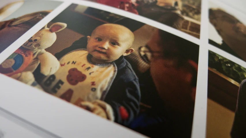 an open book showing multiple pictures of a baby