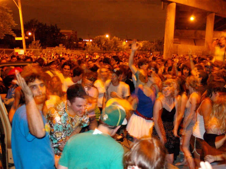 a large group of people standing outside in front of a crowd