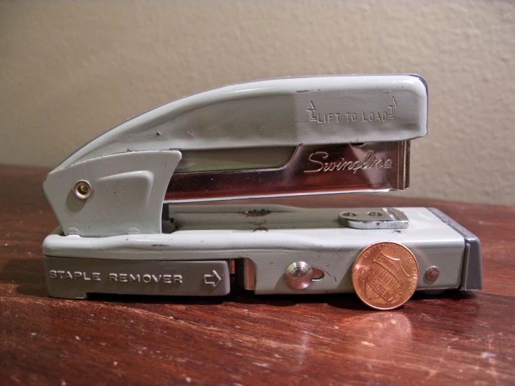 small plastic cutter with a penny sitting in front of it