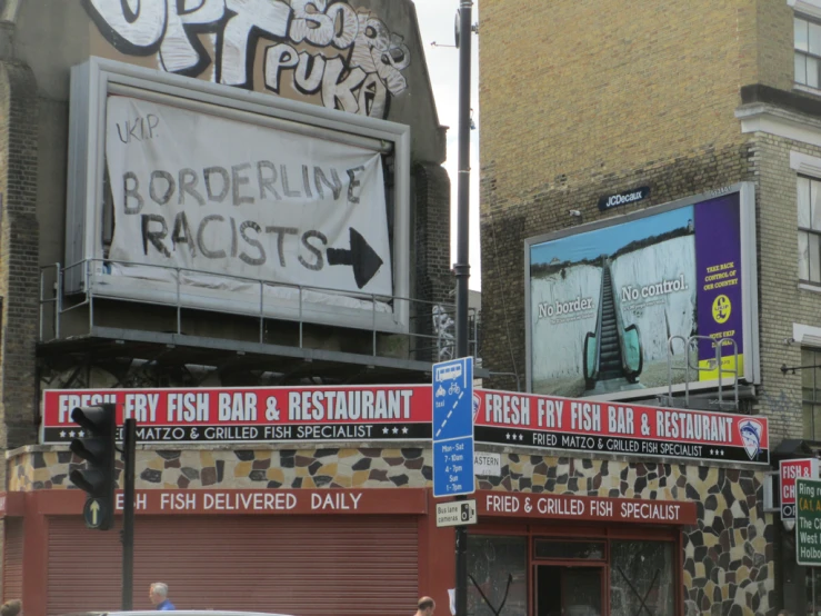 a bunch of signs that are by some buildings