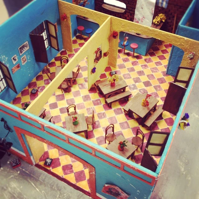 a toy house on top of a table with its furniture