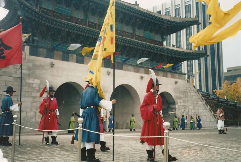 people in costumes are standing around with flags