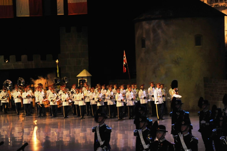 a group of people in uniforms are standing on a stage