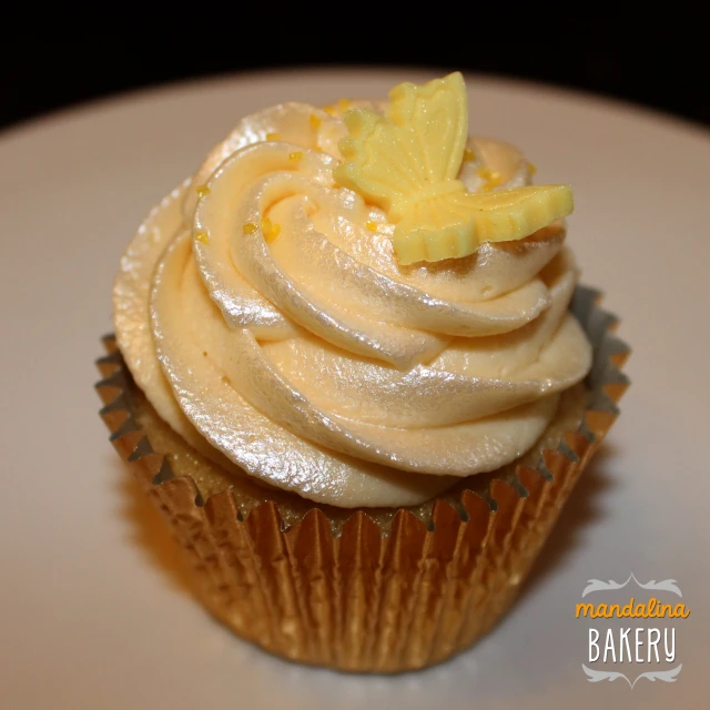 a cupcake with icing and cheese on top