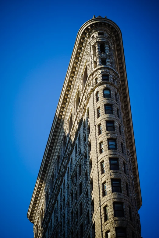 a big building is on the corner and looks up